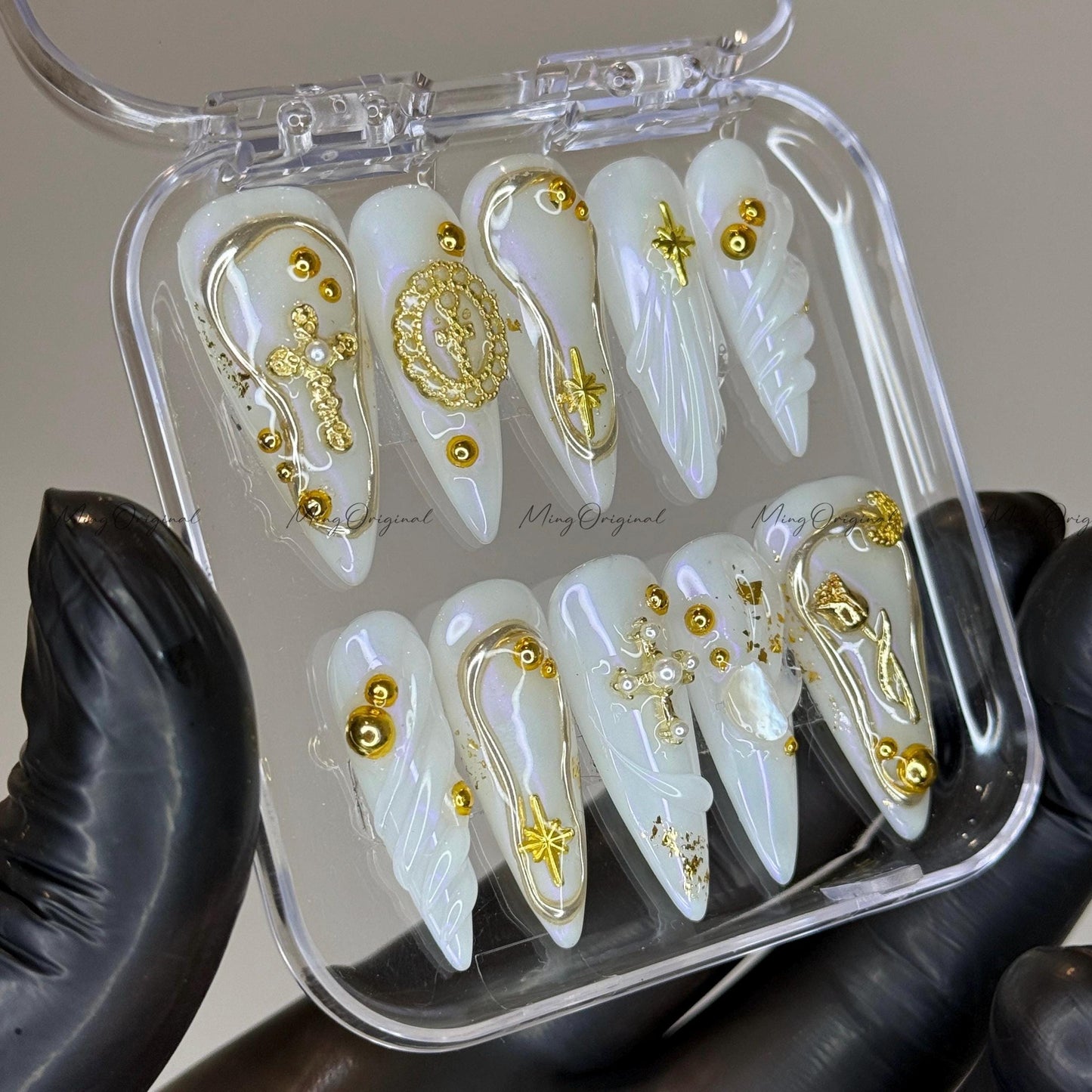 Gold celestial press on nails, iridescent white 3D charm nails with cross, moon, and star accents, luxury handmade nail art set,MO523